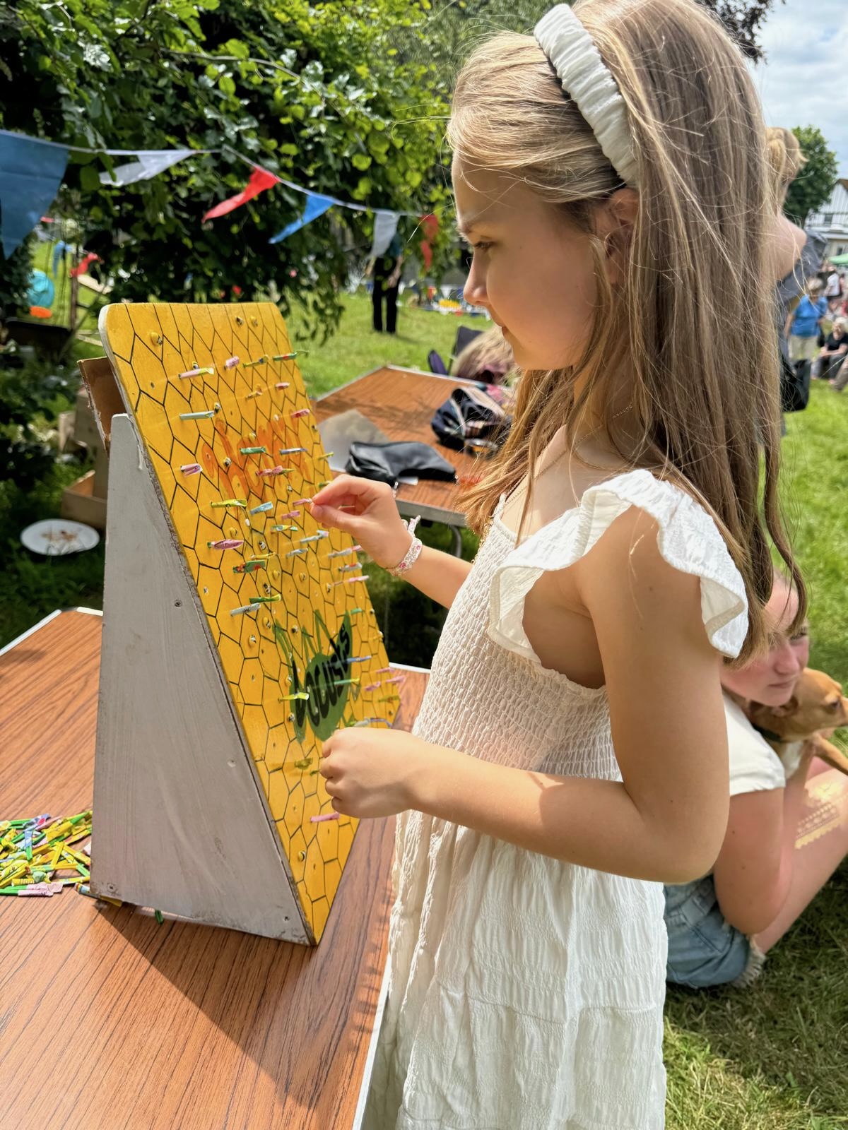 Girl playing the honey and locust game choosing a matchstick